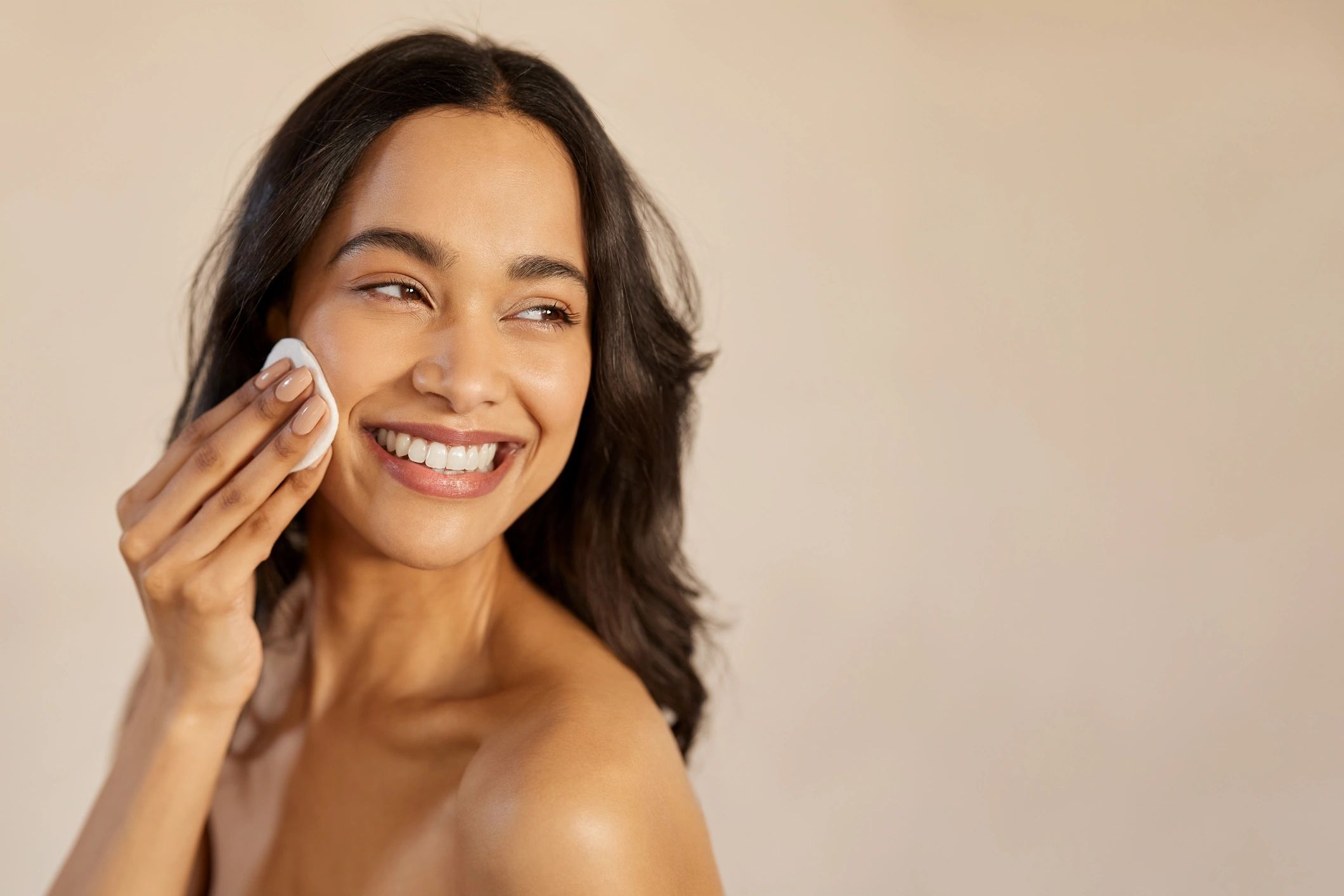 Woman removing makeup as part of a skincare and med spa beauty routine